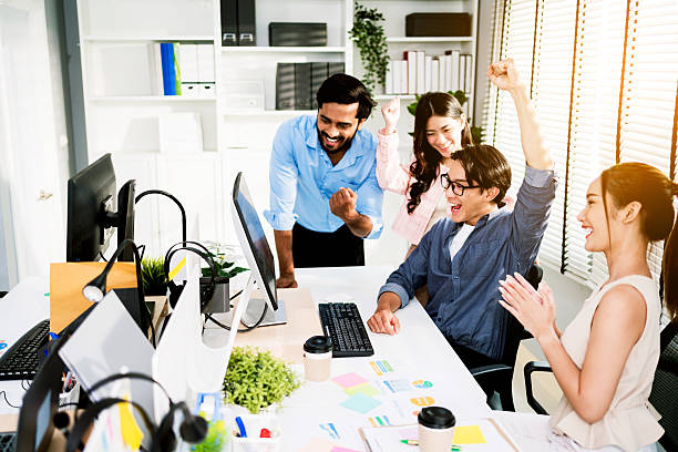 istock Diverse business team celebrating success in modern office. Group cheers joyfully at computer screen, showing teamwork, achievement, and motivation in a productive, collaborative workspace. 2227502262