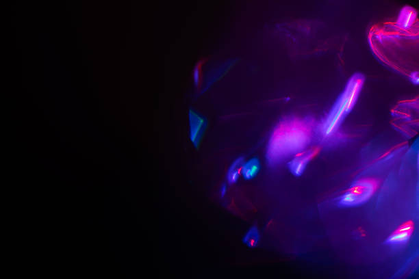 istock Blurred Light painting one exposure in camera. light glares with a spectral gradient on a dark background. 2227505298