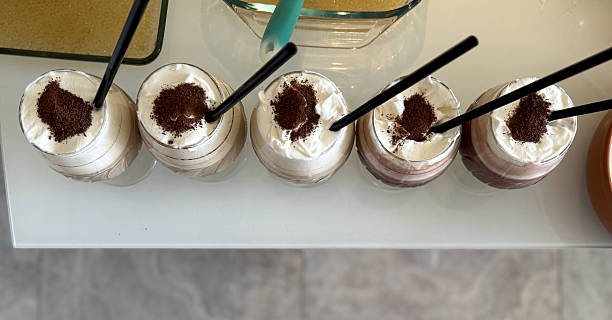 istock Coffee boba drinks on the table, top view. Cold brew coffee with Tapioca pearls. Drinking glasses of iced bubble tea with whipped cream and grated chocolate. Homemade refreshing drinks 2227506885