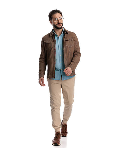 istock attractive casual guy with glasses looking away and walking 2227507232