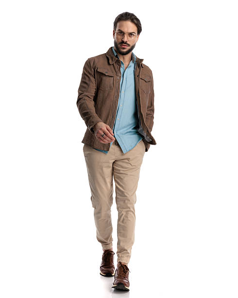 istock casual bearded guy with glasses walking with hand in pocket 2227507391