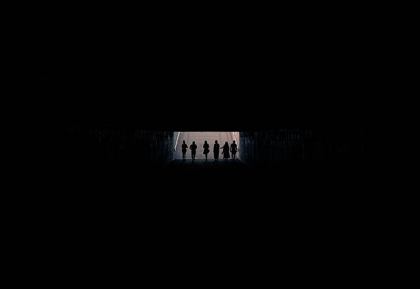 people's silhouette in black underground square frame passage foot path way background pattern concept with empty copy space