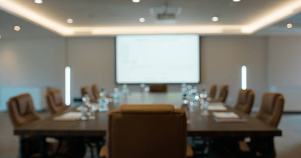istock Meeting room, conference or blur with screen or chairs for boardroom presentation in workshop. Empty space, display or projector with graph, chart or interior for business tradeshow or workplace 2227509508
