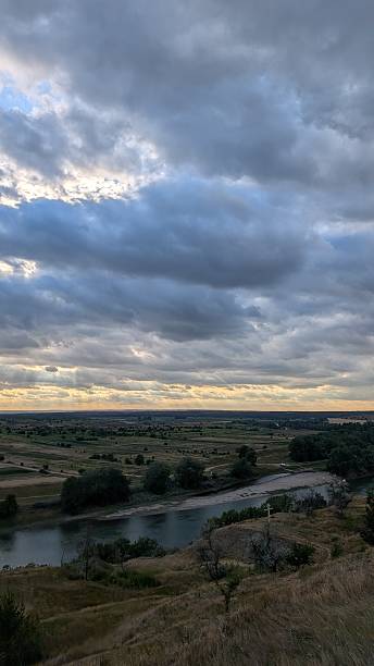 istock A Serene Landscape Featuring a Meandering River Surrounded by Dramatic, Colorful Clouds 2227510383