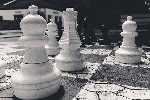 istock Intricate chess pieces poised for an intense match in a sunlit courtyard 2227510761