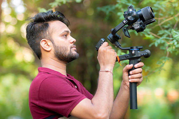 istock Videographer exploring nature and filming with camera and stabilizer gimbal in nature. 2227510769