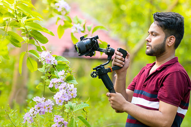 istock Videographer exploring nature and filming with camera and stabilizer gimbal in nature. 2227510777