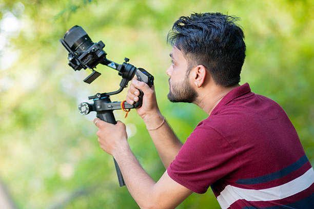 istock Videographer exploring nature and filming with camera and stabilizer gimbal in nature. 2227510778