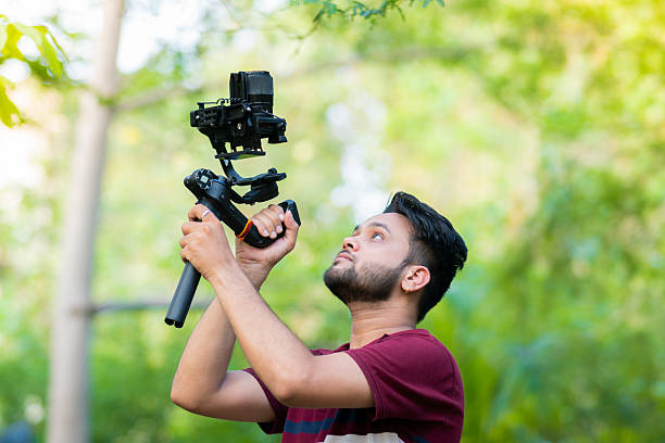 istock Videographer exploring nature and filming with camera and stabilizer gimbal in nature. 2227510784