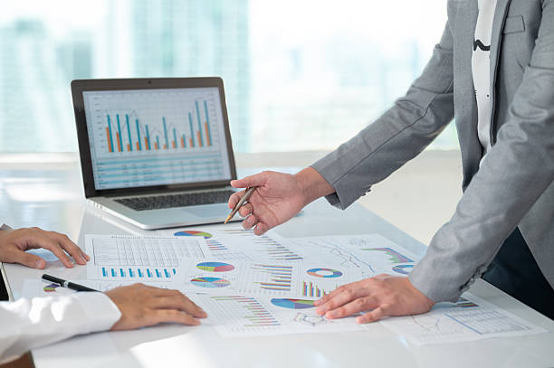 accountant team review accounts report and using digital accounting program software on computer for working accounting standards system at office. stock photo