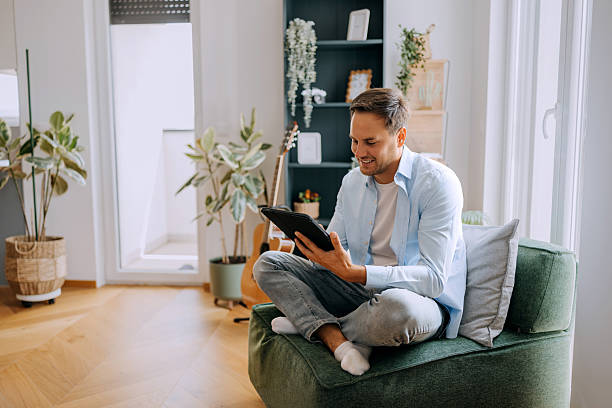 istock Man relaxing at home and using digital tablet at home. 2227513920