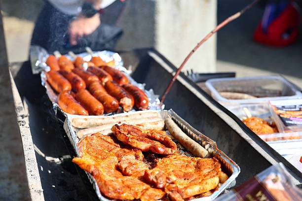 istock Grilled sausages and pork chops on a barbecue 2227514164