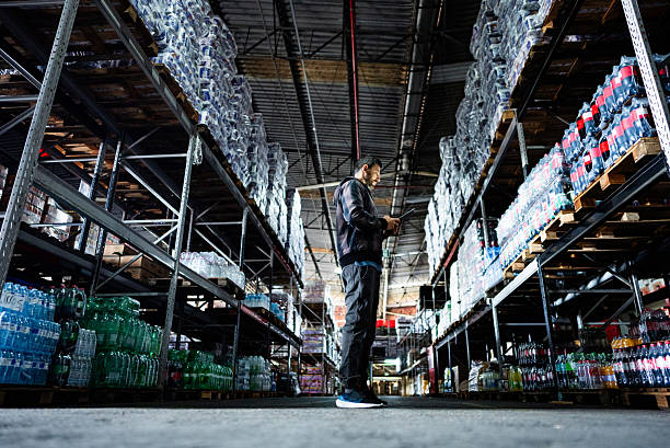 istock Mature businessman working on a digital tablet in a warehouse 2227515493