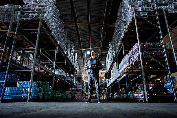 istock Mature businessman working on a digital tablet in a warehouse 2227515525
