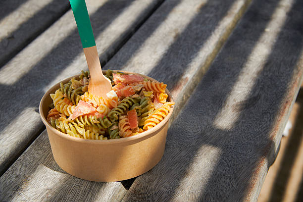 istock pasta salad served in a brown paper takeout bowl 2227515544