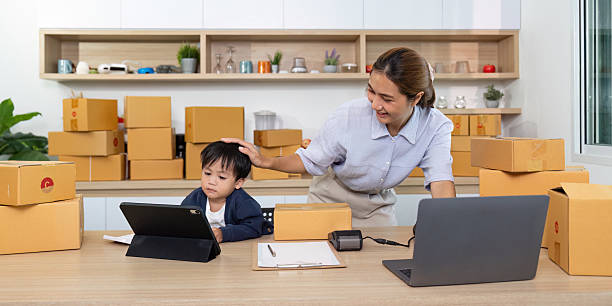 Remote Work and Family. Mother assisting child with tablet while managing home office.
