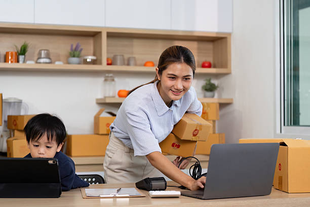 istock Working Mom Balancing Tasks with Child in Home Office 2227516755