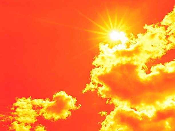 istock Bright sun with beautiful beams in the sky with clouds (toned in red) 2227517048