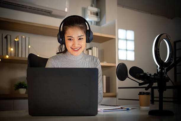 istock Podcast host engaging with audience from a cozy home studio 2227517092