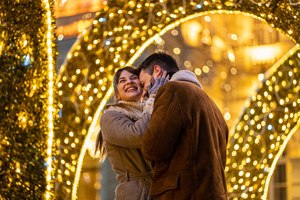 istock Happy couple hugging outdoors during holiday season 2227517667