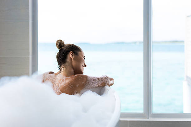 istock Beautiful woman day dreaming while being in bathtub. 2227519579