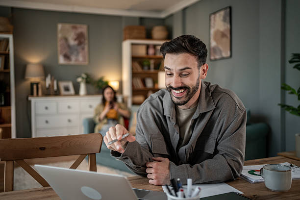 istock Young man working from home and having a video call on his laptop 2227520069