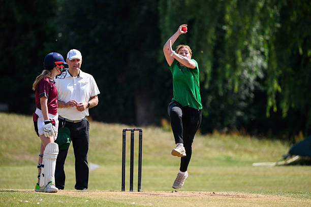 istock Front view mature woman bowling during a cricket game 2227520376