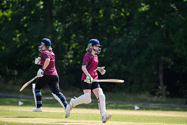 istock Female batsmen scoring a run passing each other on the pitch 2227520393