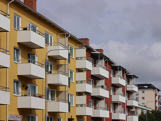 istock Low angle view of buildings against cloudy sky 2227521332