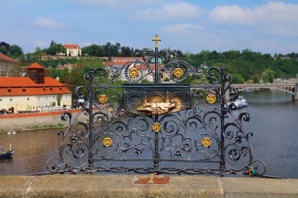 Charles Bridge in Prague. Czech name: Karluv Most. Bronze sculpture of martyr Saint John of Nepomuk, rubbed by visitors for good luck.