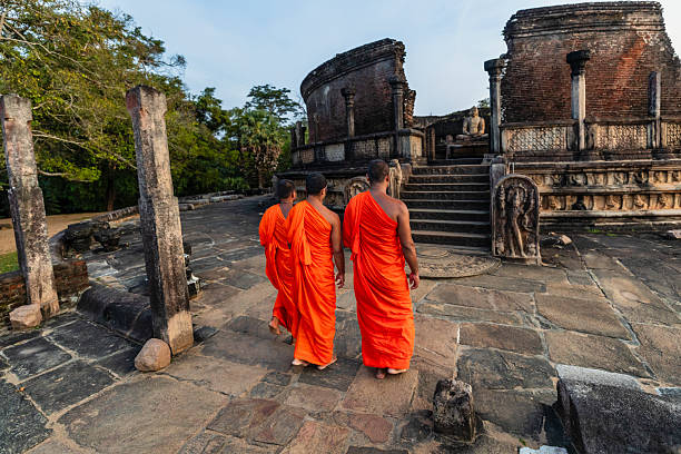 istock Sri Lankan buddhist monks walking inside an ancient temple, Ceylon 2227525983