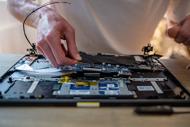 istock Man repairing laptop with tools on table, computer maintenance concept 2227526028