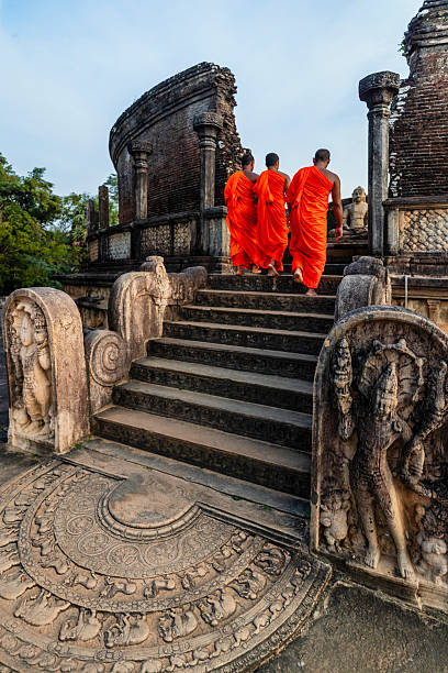 istock Sri Lankan buddhist monks walking inside an ancient temple, Ceylon 2227526034