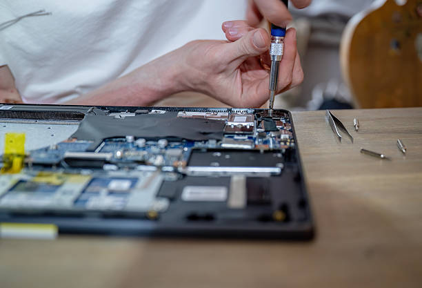 istock Man repairing laptop with tools on table, computer maintenance concept 2227526632