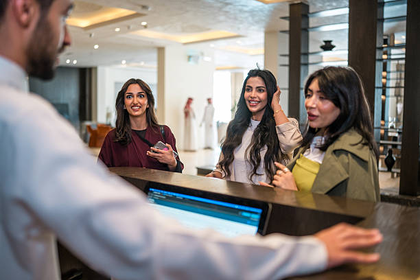 istock Young Middle Eastern Women At Modern Hotel Reception Desk Having Friendly Conversation 2227530709