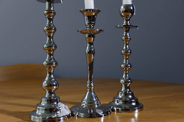 Elegant Silver Candlesticks Displaying a Modern Aesthetic on a Wooden Table Under Soft Lighting for an Inviting Home Ambiance