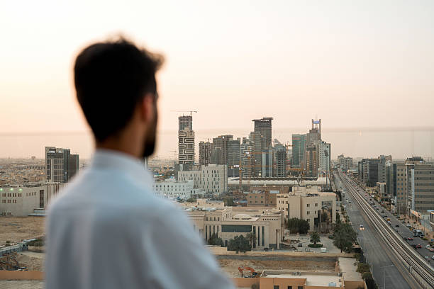 istock Young Arab Professional Admiring Modern Riyadh Skyline From Rooftop During Golden Hour 2227533015
