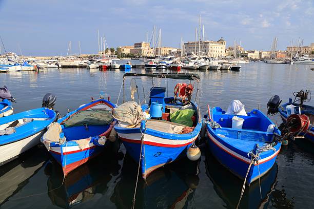 Syracuse city in Sicily, Italy. Fishing harbor blue boats.