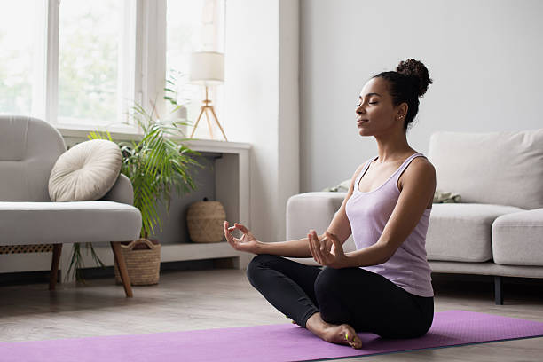 istock Woman practicing yoga, doing relaxation exercises, meditating at home 2227538028