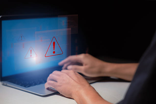 istock Cybersecurity warning concept with alert signs appearing on a laptop screen, representing system threats, malware, data breaches. IT security services and digital risk content. 2227538055