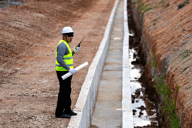 istock An Asian civil engineer in safety gear supervising a construction project by a railway. 2227540849