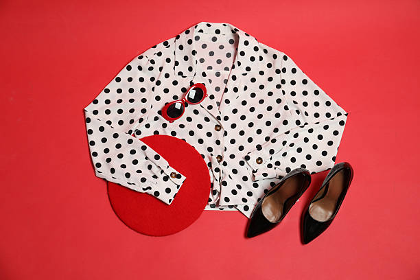 Retro styled outfit on red background, flat lay