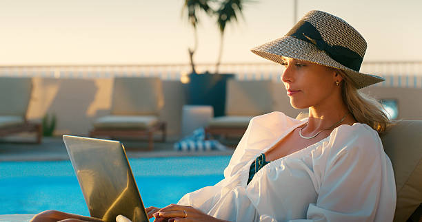 istock Pool, woman and laptop on vacation for remote work as influencer, content creator or digital nomad. Hotel guest, five star stay and freelancer with tech for holiday review, blog and typing outdoor 2227541936