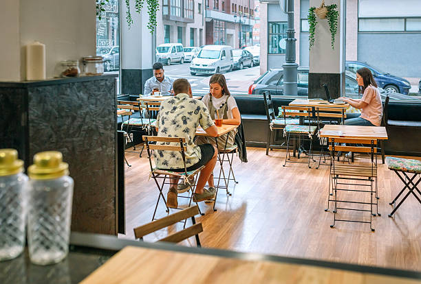 istock People enjoying their time working and relaxing at a modern cafe 2227541978