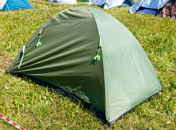 istock A green tent is sitting in a grassy field 2227542606