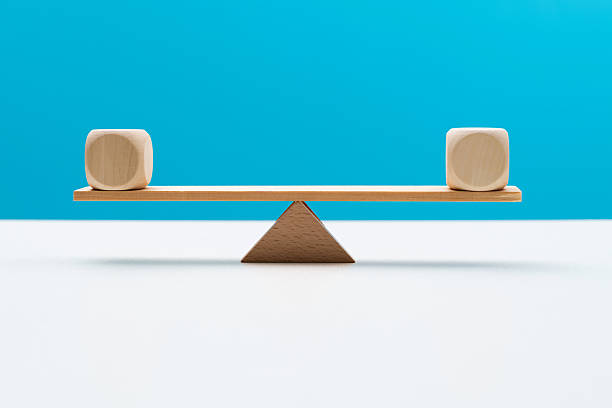Blank cubes on wooden seesaw.