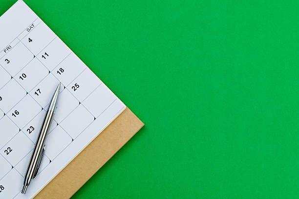 Calendar page with a ballpoint pen.