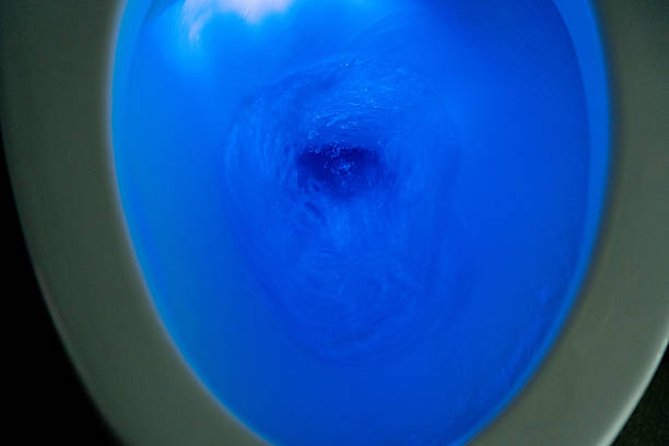 Flushing toilet with blue light.