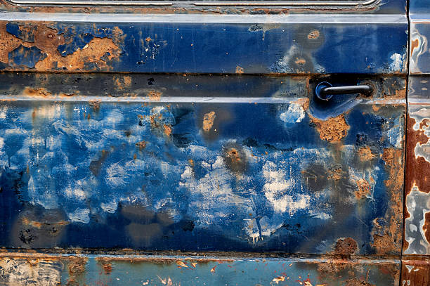 istock Damaged rusted car texture with peeling paint and corroded metal surface 2227543029