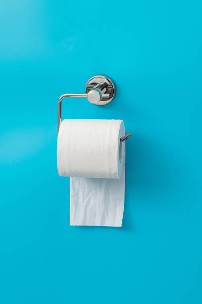 istock Toilet paper hanging on blue background 2227543032